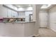 Open kitchen design with granite countertop bar and stainless steel refrigerator at 50 E Serene Ave # 107, Las Vegas, NV 89123
