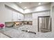 Bright kitchen featuring granite counters, white cabinets, and stainless steel appliances at 50 E Serene Ave # 107, Las Vegas, NV 89123