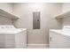 Laundry room with a washer, dryer, and overhead shelving at 50 E Serene Ave # 107, Las Vegas, NV 89123