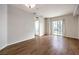 Bright living room featuring hardwood floors and a sliding glass door to a balcony at 50 E Serene Ave # 107, Las Vegas, NV 89123
