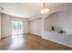 Bright living room with hardwood floors, recessed lighting, and a sliding glass door to a balcony at 50 E Serene Ave # 107, Las Vegas, NV 89123