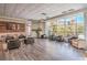 Comfortable resident lounge featuring modern furniture, wood floors, and large windows at 50 E Serene Ave # 107, Las Vegas, NV 89123