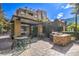 Community outdoor kitchen and dining area with grills and seating at 50 E Serene Ave # 107, Las Vegas, NV 89123