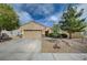 Charming single-story home featuring a well-manicured front yard and a spacious two-car garage at 7460 Chaffinch St, North Las Vegas, NV 89084