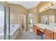 Bright bathroom with dual vanities, a soaking tub, and a glass-enclosed shower at 8208 Flowing Rapids Ct, Las Vegas, NV 89131