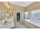 Relaxing bathroom with dual sinks, a separate shower, and a soaking tub under a bright window at 8208 Flowing Rapids Ct, Las Vegas, NV 89131