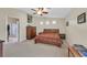 Large bedroom featuring a ceiling fan, carpet flooring, and access to the en suite bathroom at 8208 Flowing Rapids Ct, Las Vegas, NV 89131