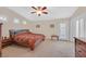 Cozy bedroom with neutral tones, carpet flooring, and a door to the exterior at 8208 Flowing Rapids Ct, Las Vegas, NV 89131