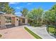 Elegant entrance with a modern pergola, landscaped gardens, and well-maintained walkways creating a welcoming atmosphere at 8208 Flowing Rapids Ct, Las Vegas, NV 89131