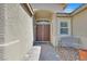Inviting front entryway with a double door, textured walls, tiled walkway, and wrought iron bench for seating at 8208 Flowing Rapids Ct, Las Vegas, NV 89131