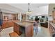 Well-lit kitchen featuring ample counter space and a breakfast bar that seamlessly connects to the living space at 8208 Flowing Rapids Ct, Las Vegas, NV 89131