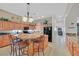Large kitchen with a central island, bar stool seating, warm lighting, and views into other living areas at 8208 Flowing Rapids Ct, Las Vegas, NV 89131
