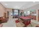 Open-concept living space with a pool table, tile floors, and views of the connecting kitchen and backyard at 8208 Flowing Rapids Ct, Las Vegas, NV 89131
