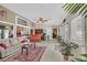 Bright sunroom features a bar, tile floors, and large windows offering views of the backyard at 8208 Flowing Rapids Ct, Las Vegas, NV 89131