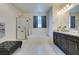 This bright bathroom features a soaking tub, shower, and dual vanity with granite countertops at 8637 Home Gate Ct, Las Vegas, NV 89113