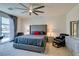 This primary bedroom has an upholstered headboard, ceiling fan and overlooks backyard at 8637 Home Gate Ct, Las Vegas, NV 89113