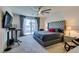 Spacious bedroom with a large bed, ceiling fan, and sliding glass doors to the backyard at 8637 Home Gate Ct, Las Vegas, NV 89113