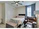 Comfortable bedroom featuring a ceiling fan, an accent chair and a full-sized bed at 8637 Home Gate Ct, Las Vegas, NV 89113