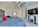 Charming primary bedroom boasts a large bed, ceiling fan, and convenient entertainment center at 8637 Home Gate Ct, Las Vegas, NV 89113