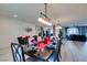 Open-concept dining area featuring contemporary lighting, modern decor and seamless flow at 8637 Home Gate Ct, Las Vegas, NV 89113