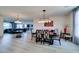 Dining room with stylish lighting and views into a living area and kitchen at 8637 Home Gate Ct, Las Vegas, NV 89113