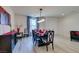 Elegant dining area with a dark wood table, stylish chairs, and modern lighting at 8637 Home Gate Ct, Las Vegas, NV 89113