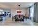 Formal dining room featuring elegant light fixtures, decor and an open concept living area at 8637 Home Gate Ct, Las Vegas, NV 89113