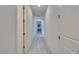 Well-lit hallway with white walls and light wood-look flooring and white doors at 8637 Home Gate Ct, Las Vegas, NV 89113
