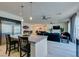 Spacious open concept kitchen to the living room featuring a large refrigerator and an island at 8637 Home Gate Ct, Las Vegas, NV 89113
