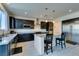 Modern kitchen featuring stainless steel appliances, dark cabinets, and granite countertops at 8637 Home Gate Ct, Las Vegas, NV 89113