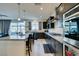 Bright kitchen showcasing an island with bar seating, granite counters, and backyard pool view at 8637 Home Gate Ct, Las Vegas, NV 89113