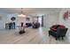 Open-concept living and dining area with modern light fixtures and elegant decor accents at 8637 Home Gate Ct, Las Vegas, NV 89113