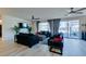 Bright living room with hardwood floors, a ceiling fan, and backyard access at 8637 Home Gate Ct, Las Vegas, NV 89113