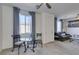 Bright, open living space features a glass table, cozy sitting area, and natural lighting at 8637 Home Gate Ct, Las Vegas, NV 89113