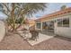 Home featuring an enclosed backyard area with neutral colored stone landscaping and patio at 9532 Calico Garden Ave, Las Vegas, NV 89134