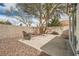 Cozy backyard patio featuring desert landscaping, stone ground cover, and a mature shade tree at 9532 Calico Garden Ave, Las Vegas, NV 89134