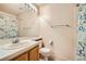 Functional bathroom featuring a sink, toilet, mirror, and shower with a patterned curtain at 9532 Calico Garden Ave, Las Vegas, NV 89134
