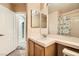 Functional bathroom featuring a single sink, toilet, mirror, and shower with a patterned curtain at 9532 Calico Garden Ave, Las Vegas, NV 89134