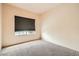 A bedroom featuring neutral carpeting and a window with horizontal blinds at 9532 Calico Garden Ave, Las Vegas, NV 89134