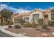 Front elevation of a single-story home with a terracotta roof, xeriscape landscaping, and two car garage at 9532 Calico Garden Ave, Las Vegas, NV 89134