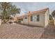 Back exterior view featuring neutral stucco, a terra cotta roof, patio, and desert landscaping at 9532 Calico Garden Ave, Las Vegas, NV 89134