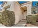 Close up shot of front door with stucco exterior and desert landscaping including rocks and succulent plants at 9532 Calico Garden Ave, Las Vegas, NV 89134