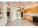Functional kitchen with tile flooring, wood cabinets, and modern appliances at 9532 Calico Garden Ave, Las Vegas, NV 89134
