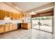 Functional kitchen with tile floor, wooden cabinets and access to the backyard at 9532 Calico Garden Ave, Las Vegas, NV 89134
