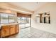 Bright kitchen with tile floors, wooden cabinets, and sliding glass doors to the backyard at 9532 Calico Garden Ave, Las Vegas, NV 89134