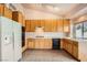 Functional kitchen with tile flooring, wooden cabinets, and modern appliances at 9532 Calico Garden Ave, Las Vegas, NV 89134