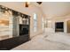Bright living room featuring neutral carpet, a built-in mirrored display, and high ceilings at 9532 Calico Garden Ave, Las Vegas, NV 89134