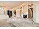 Open floor plan features a carpeted living room with fireplace and arched doorways at 9532 Calico Garden Ave, Las Vegas, NV 89134