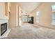 Spacious living room featuring vaulted ceilings, neutral carpet, and an elegant fireplace with decorative tiling at 9532 Calico Garden Ave, Las Vegas, NV 89134