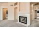 Carpeted living room featuring fireplace and arched doorways leading to other areas of the home at 9532 Calico Garden Ave, Las Vegas, NV 89134